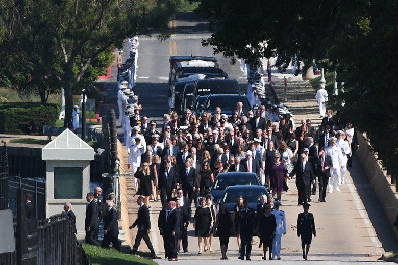 A hearse containing the body of the late Senator John McCain arrives for a private memorial service and burial at the U.S. Naval Academy in Annapolis on September 2, 2018.